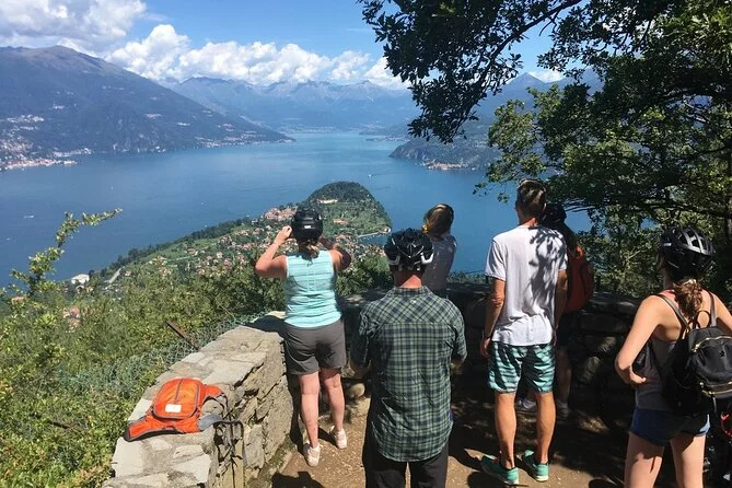 Cyclist taking picture of Lake Como